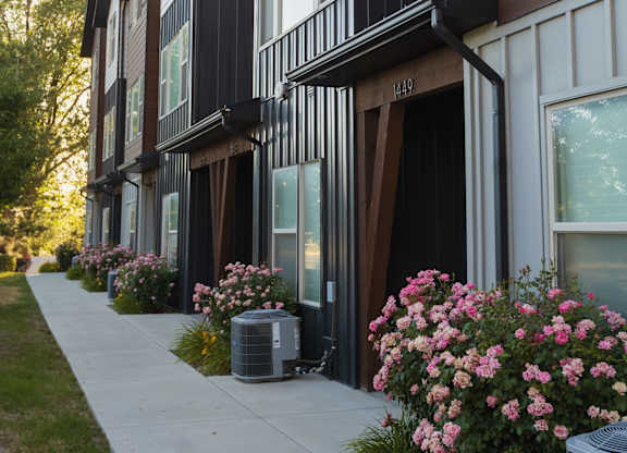 A row of townhouses with flower boxes on the front.