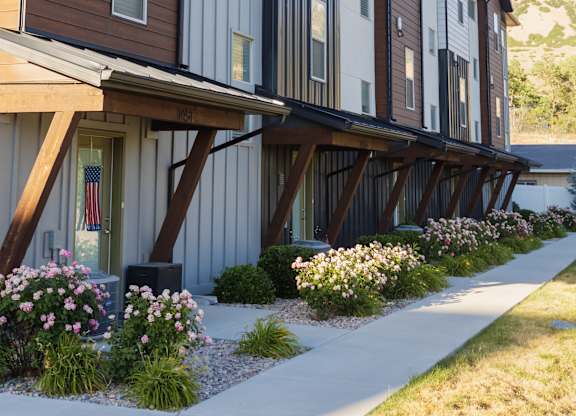 A row of modern townhouses with a mountain in the background.