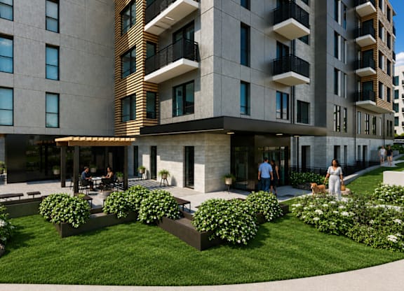 A modern building with a green lawn in front.