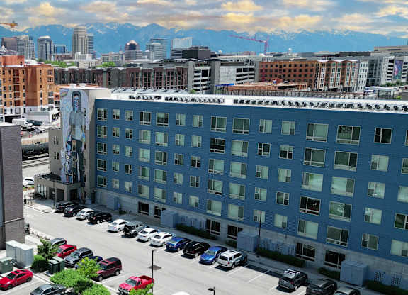 a large blue building with a parking lot in front of it