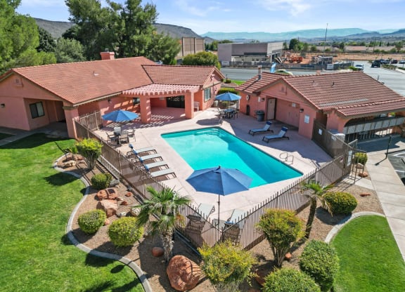 a birds eye view of a pool in front of a house