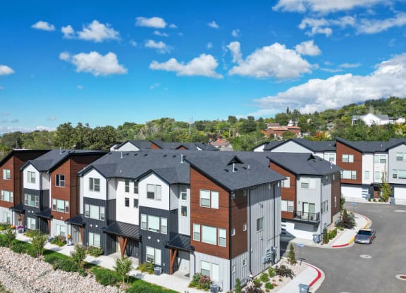 an aerial view of an apartment building with a parking lot