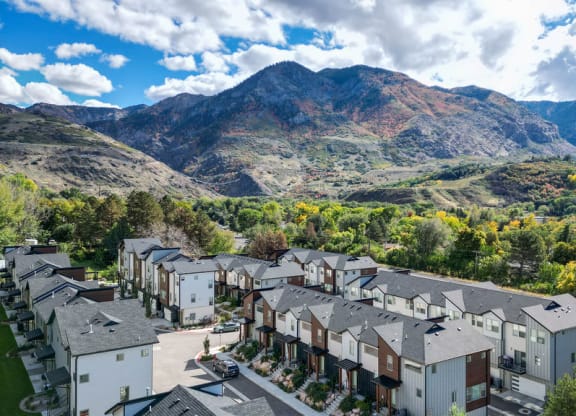 an aerial view of apartments with mountains in the background