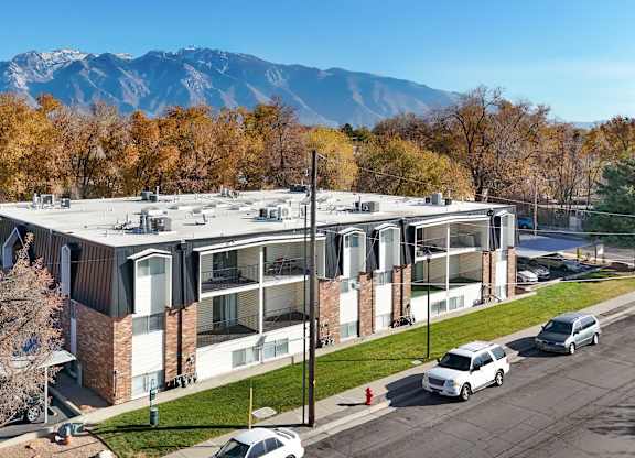 A modern building with a parking lot in front of it.
