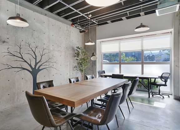 A conference room with a long table and chairs.