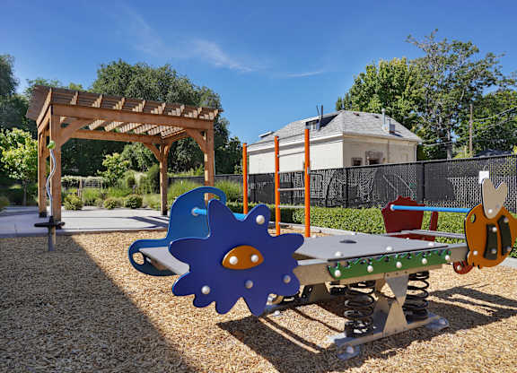 A playground with a swing set and a slide.