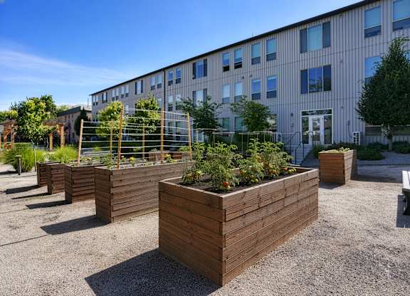 A building with a garden in front of it.
