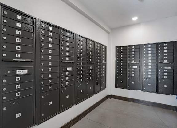 A row of black mailboxes numbered from 12 to 20.
