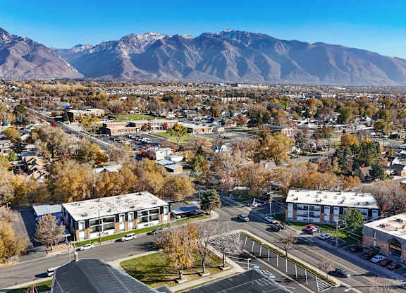 A view of a town with buildings and a mountain in the background.