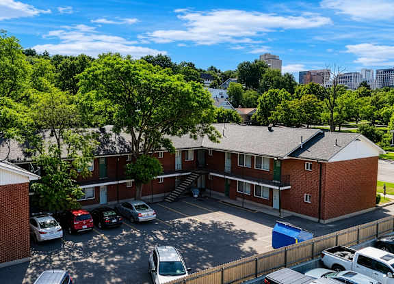 A parking lot with cars and a building in the background.