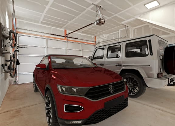 a red car and a white jeep in a garage