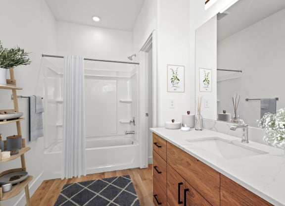 a white bathroom with a sink and a shower