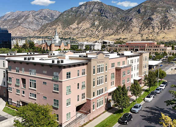 A large building with a parking lot in front of it.