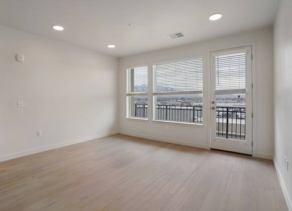 A room with a view of a snowy landscape through the windows.