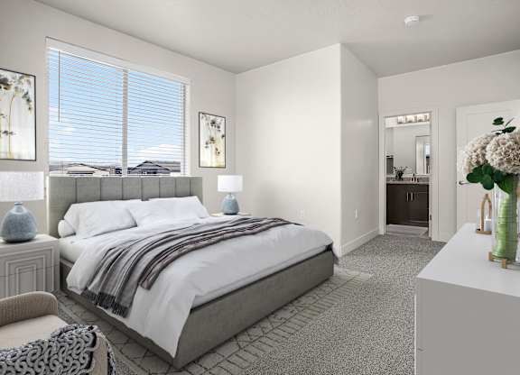 A bedroom with a large bed and a chair.