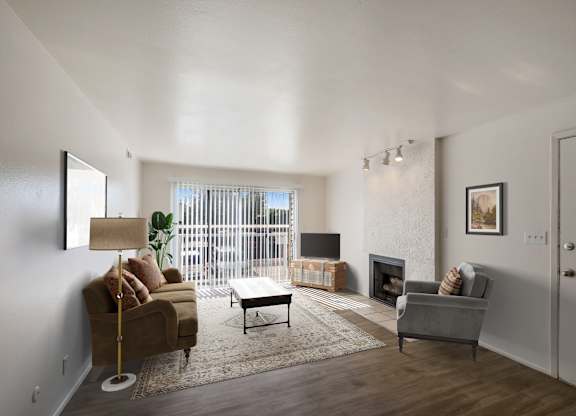 a living room with a couch and a chair and a fireplace