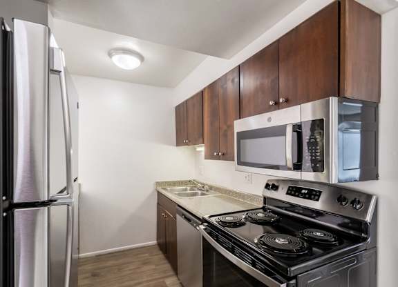 a kitchen with stainless steel appliances and wooden cabinets