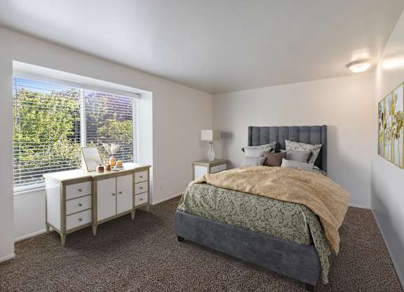 a bedroom with a bed and a large window