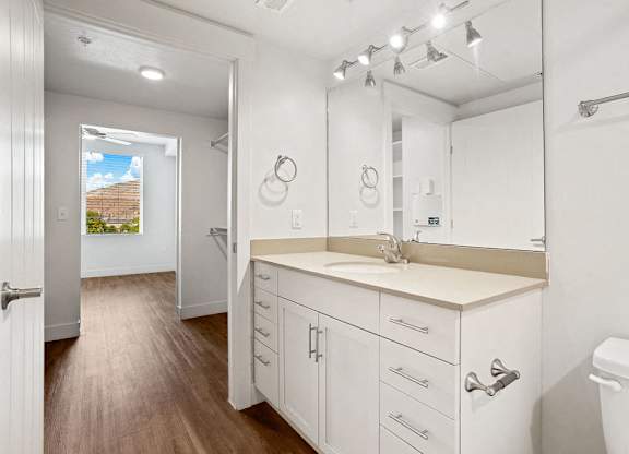 a white bathroom with a sink and a mirror