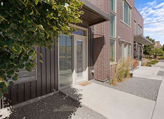 the front of a house with a sidewalk and a door
