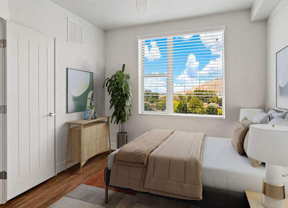 a bedroom with a bed and a window