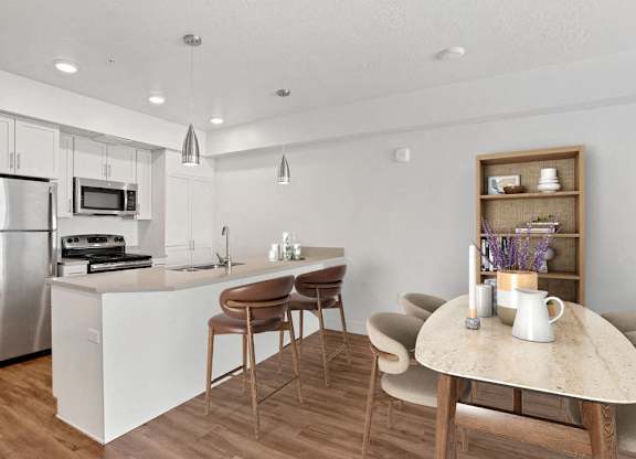 a kitchen with an island and a dining table
