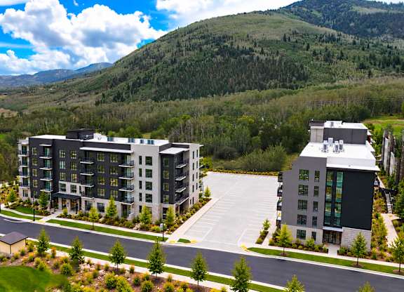 A modern building complex with a curved road in front of it.