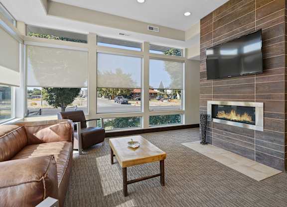 a living room with a couch and a television and a fireplace