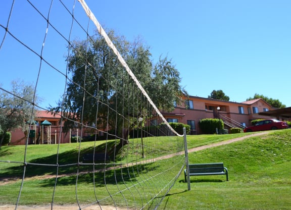 a swing set in a park in front of a building