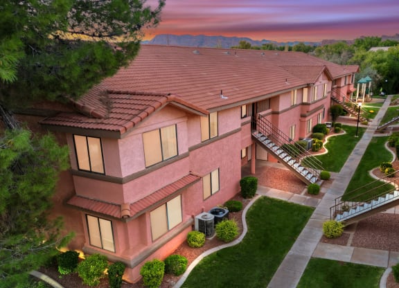an aerial view of a house with a sunset behind it