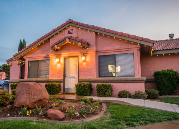 a pink house with lights on the front of it