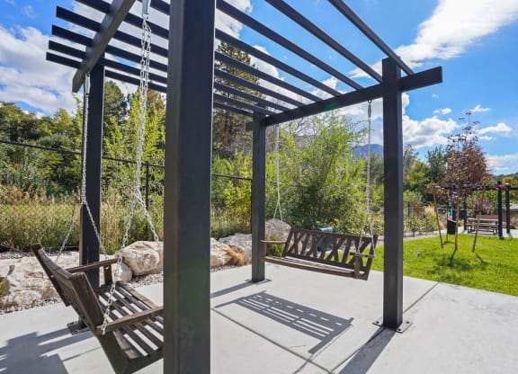 a seating area with benches and a pergola