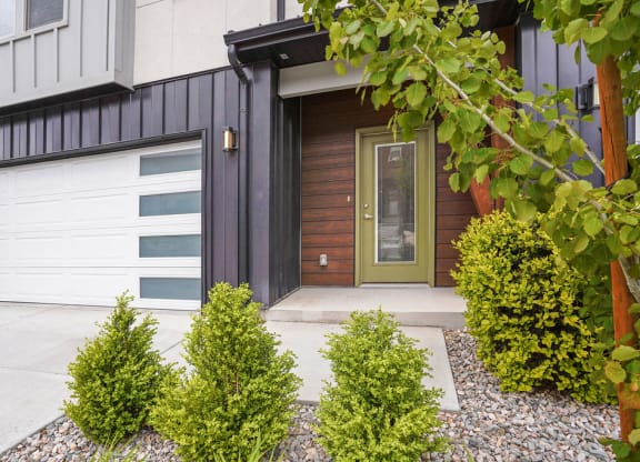 the front of a house with a driveway and a garage door