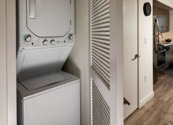 A white washing machine and dryer in a laundry room.