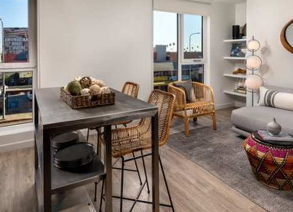 A modern living room with a dining table and chairs.