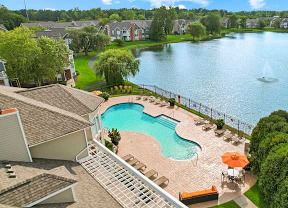 A residential area with a pool and a lake.