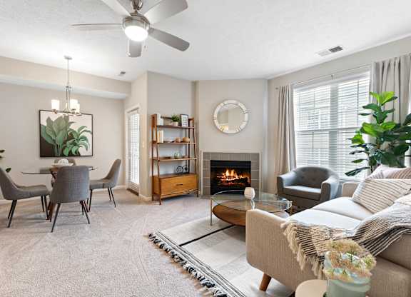 Living room with fireplace at Sand Creek Woods Apartments, Fishers, Indiana