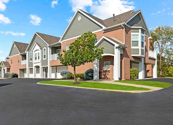 A large house with a driveway in front.
