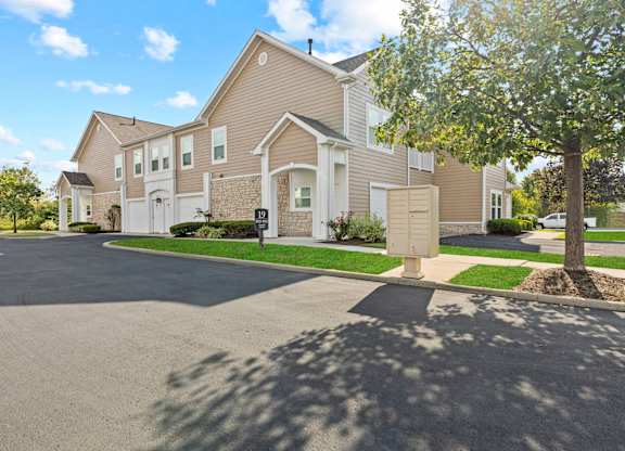 A large house with a driveway in front.
