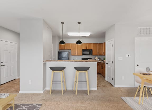 Kitchen with a breakfast bar at Aspen Lakes Apartments, Indiana