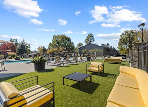 Patio with a couch and chairs at Lakes of Carmel Apartments, Carmel, Indiana