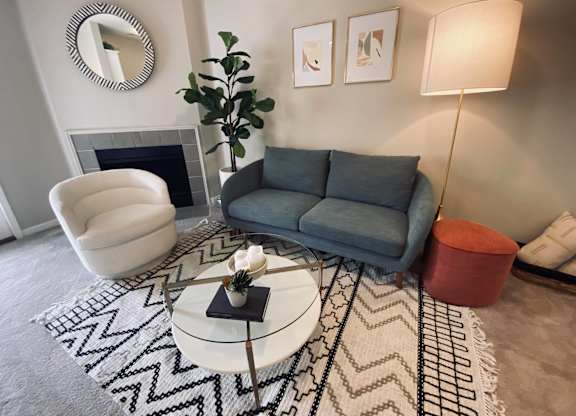 Living room with rug at Sand Creek Woods Apartments, Indiana