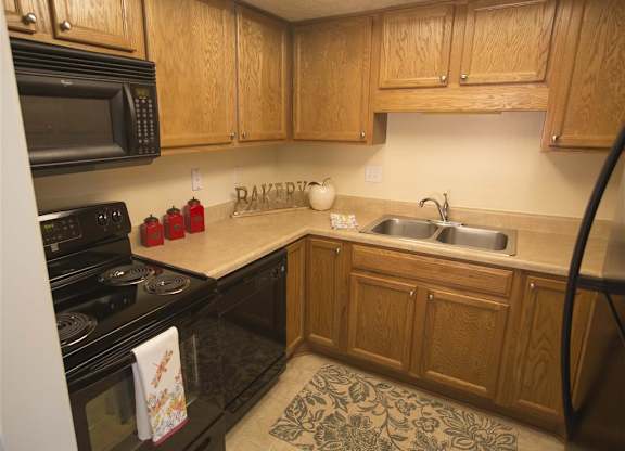 Kitchen with All New Black Appliances at Woodland Springs Apartment Homes, Carmel, 46033