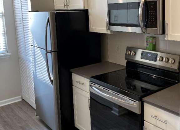 Kitchen with Stove at Sand Creek Woods Apartments, Fishers, IN