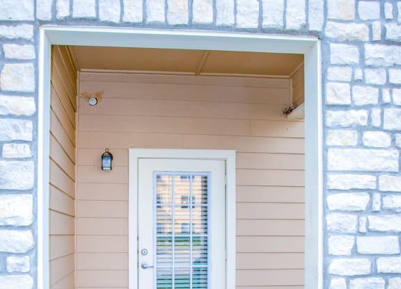 the entrance to a home with a white door