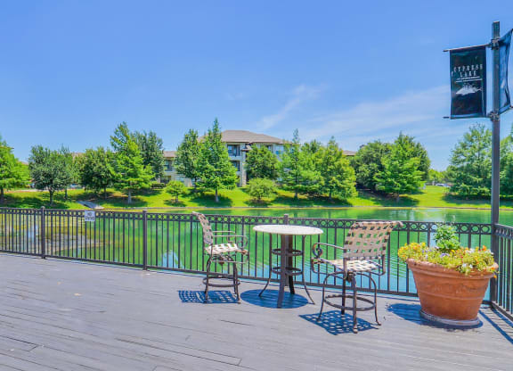 Lake doc with bistro tables and chairs at Cypress Lake at Stonebriar in Frisco, TX!