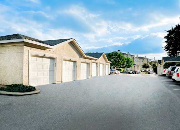 A row of houses with garages on the side.