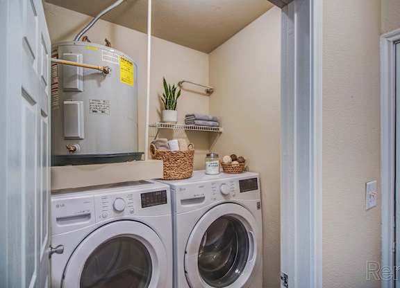 A small laundry room with a washer and dryer.