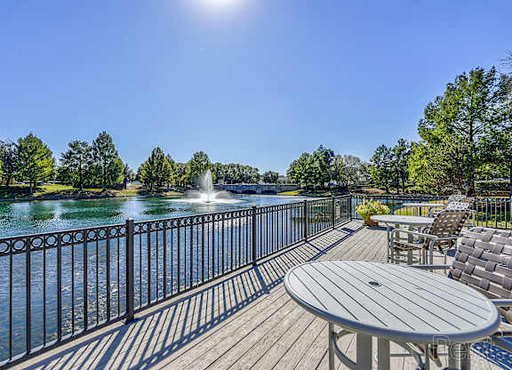 Deck with chairs overlooking the community lake  at Cypress Lake at Stonebriar Apartments, Texas