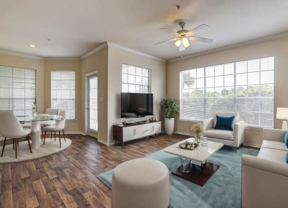 Light and bright living rooms with ample windows and hardwood floors at Turnberry Isle Apartments in Dallas, TX.
